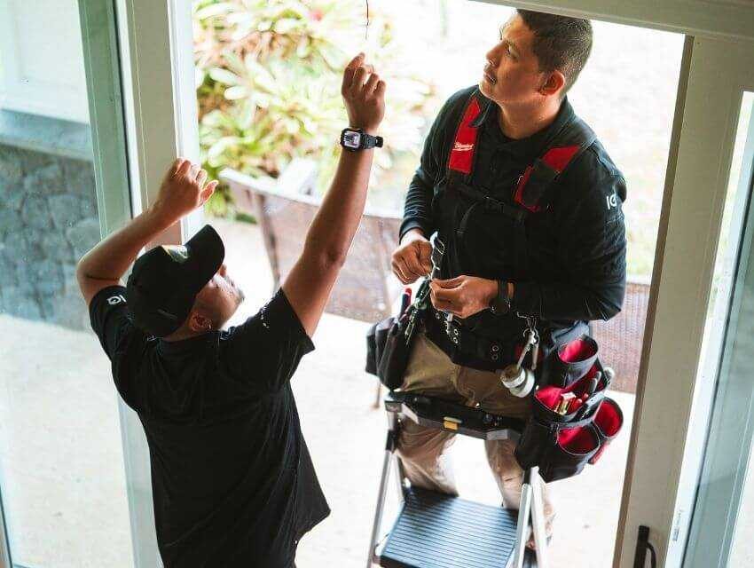 Two MPI employees installing a home security system